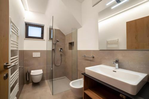 a bathroom with a sink and a toilet and a shower at Apartment Pauli in Lagundo