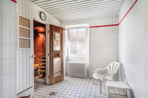 a white room with a chair and a window at Ferienwohnung Waldglück in Hinterzarten
