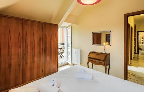 a bedroom with two white beds and a wooden wall at La dimora di Alda in Lavagna