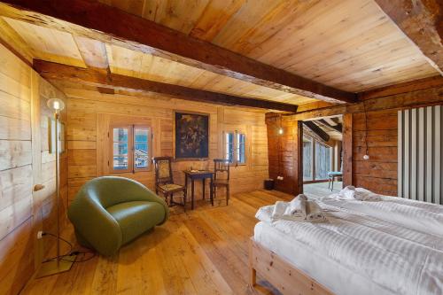 a bedroom with a bed and a chair in a room at Cedä-M in Dosoledo