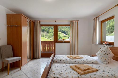 a bedroom with two beds and a window at Ferienhaus Berger in Sarntal