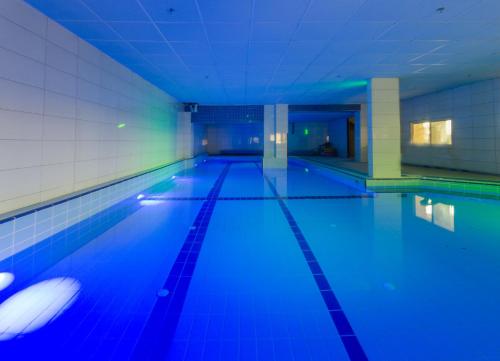 a swimming pool with blue lights in a building at Moon Cnter in Majdal Shams