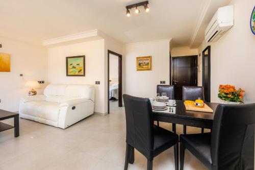 a living room with a dining table and a bed at Gala in Cala Ratjada