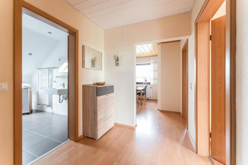 a living room with a kitchen and a dining room at Am Pön - Ferienwohnungen in Medebach