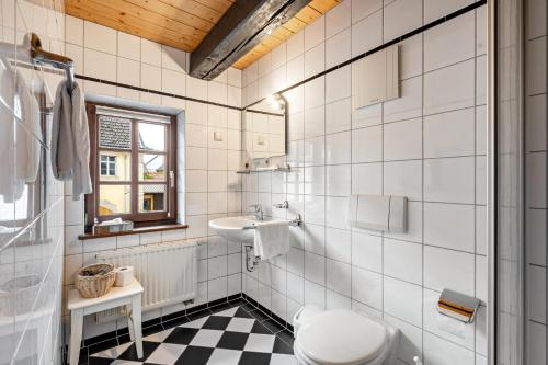 a white bathroom with a sink and a toilet at Weingut Schuh in Coswig