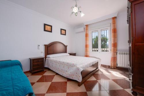 a bedroom with a bed and a couch in it at Villa Minerva in Ronda