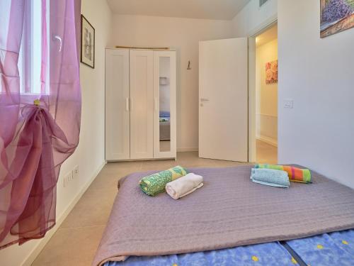 a room with a bed with two pillows on it at New Casa Tiberio in Lazise