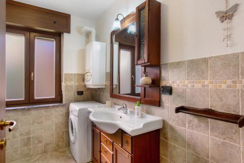 a bathroom with a sink and a toilet and a mirror at Casa Michod Chatillon - Nonna Genia in Châtillon