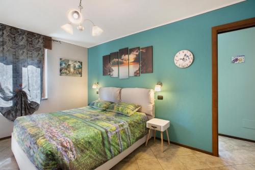 a bedroom with a bed and a blue wall at Casa Michod Chatillon - Nonna Genia in Châtillon