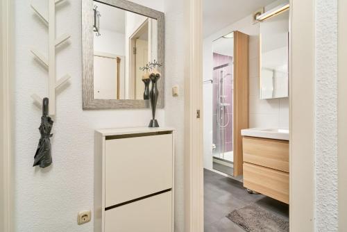 a bathroom with a mirror and a sink at Brisa Marina in Almuñécar