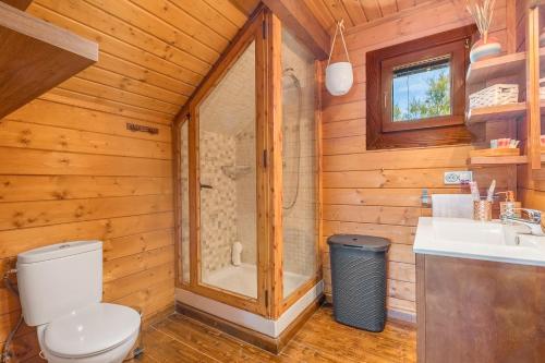 a bathroom with a toilet and a shower and a sink at Finca La Haima in Motril