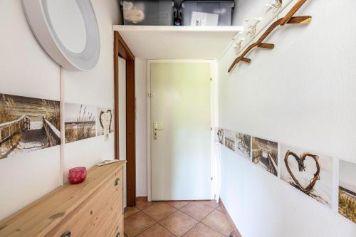 a hallway with a staircase with pictures on the wall at Ferienwohnung mit Badestrand in Glücksburg