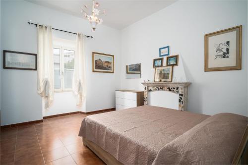 a bedroom with a bed and a fireplace at Casa Picchereddu in Orosei