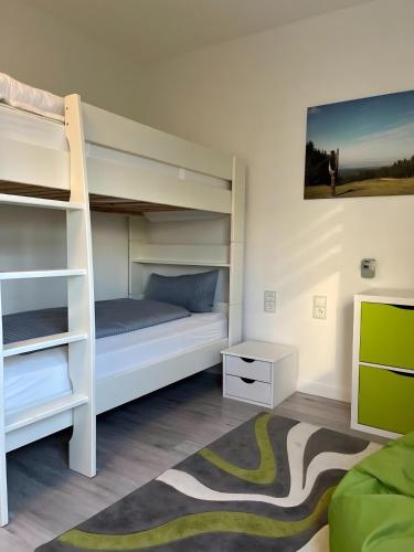 a bedroom with two bunk beds and a rug at Ferienwohnung deluxe in Goslar