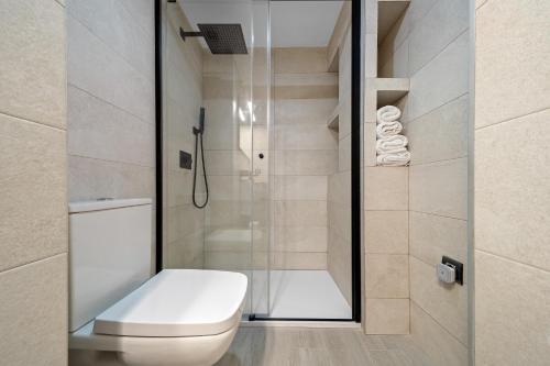 a bathroom with a toilet and a shower at Kaixo in Calafell