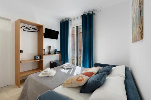 a bedroom with a bed with blue curtains at I Tramonti Del Golfo - Kennedy in Balestrate
