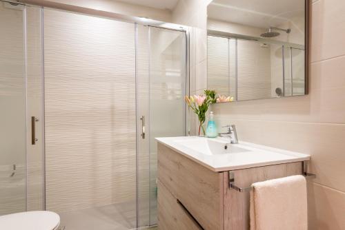 a bathroom with a sink and a glass shower at Delta 3 in Sóller
