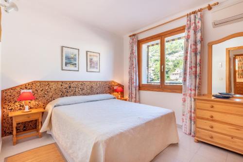 a bedroom with a bed and a window at Delta 3 in Sóller