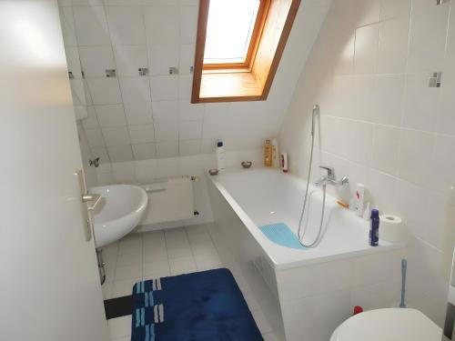 a white bathroom with a sink and a toilet at Ferienwohnung Max und Moritz in Mirow