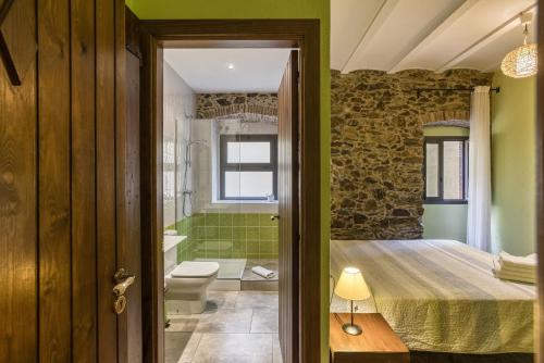 a bathroom with a shower and a toilet in a room at Casa Rural El Torn in Garriguella