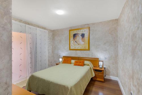 a bedroom with a bed with orange pillows at Casa Santana in Vecindario