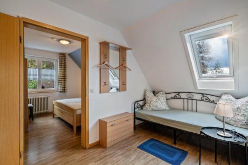 a small room with a bed and a window at Dorerhof Prechtal in Elzach