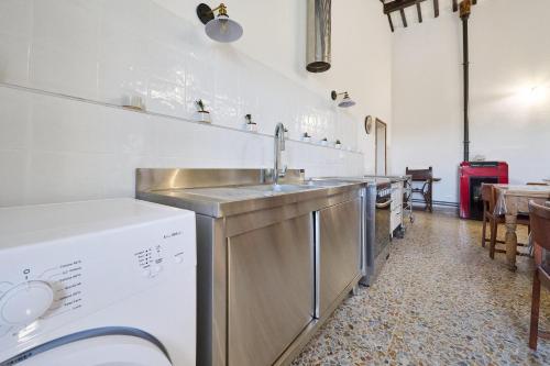 a kitchen with a sink and a dishwasher at Il Podere Del Ponti - Paduletto in Casa Paduletto