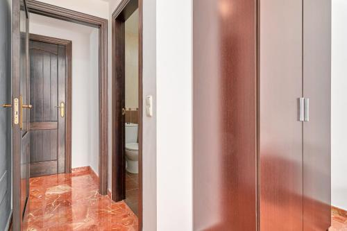 a bathroom with a glass door and a toilet at Casa Axarquia in Vélez-Málaga