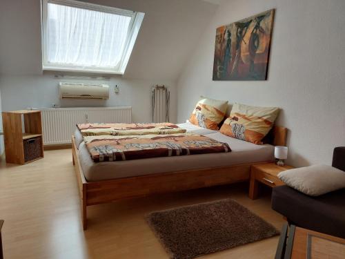 a small bedroom with a bed and a window at Apartment Schwär in Endingen
