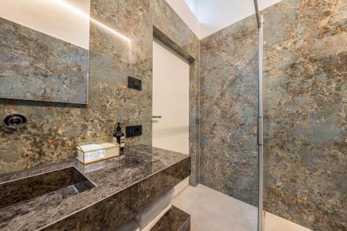 a bathroom with a shower with a glass door at App 302 Palazzo Cavour in Bolzano