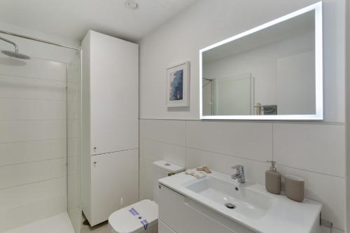 a white bathroom with a sink and a mirror at Lupama Suite in Arguineguín