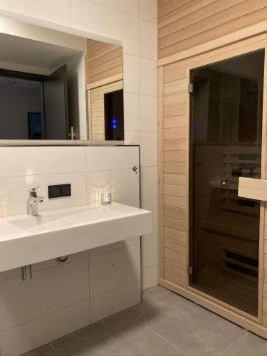 a bathroom with a sink and a mirror at Wellness Appartement Winterberg E2 in Winterberg