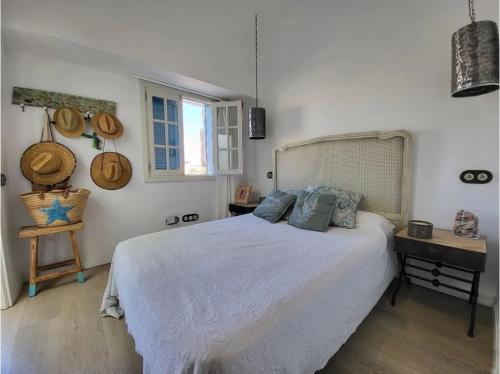a bedroom with a bed and a table and a window at Villa Delicias in Melenara