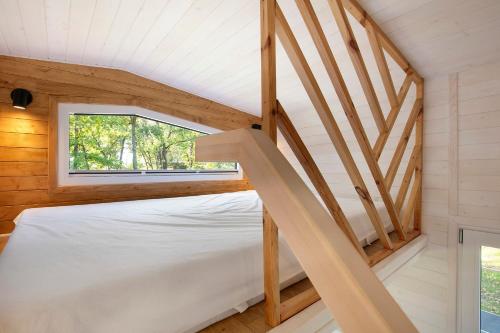 a bedroom with a staircase in a tiny house at Tiny House Nr 5 in Schwielowsee