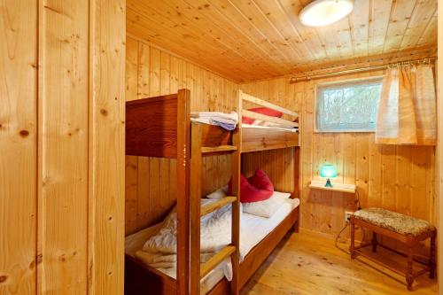 a bedroom with bunk beds in a wooden cabin at Bungalow 10 - Finnhütte in Niesky