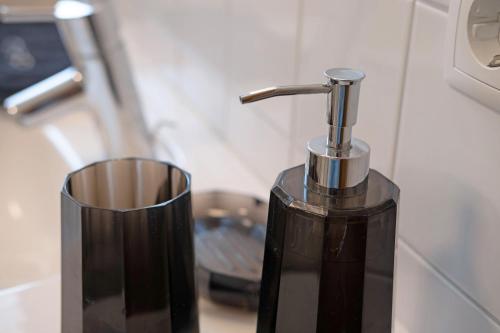 a black soap dispenser next to a trash can at Marinushof in Kastelbell-Tschars