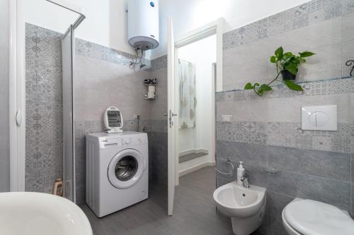 a bathroom with a washing machine and a sink at Dormiamoci Sù in Mottola