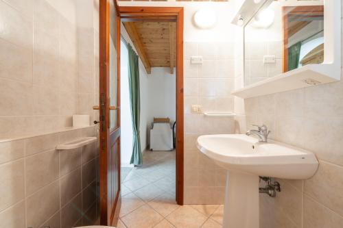 a bathroom with a sink and a mirror at Casa Silvia in Calasetta