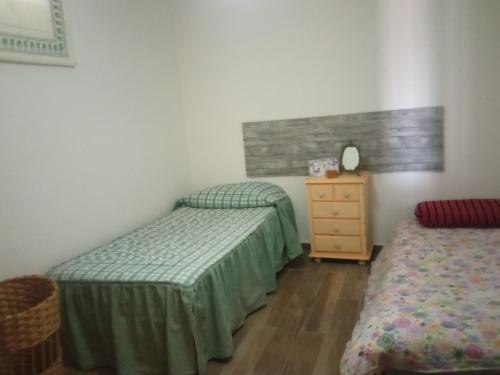 a bedroom with two twin beds and a dresser at Villa Lukita in Cangas de Morrazo