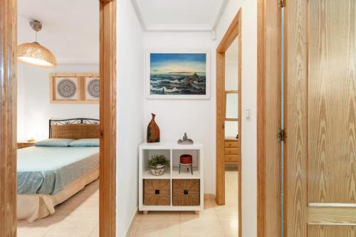a bedroom with a bed and a white cabinet at Casa Max in Gran Alacant