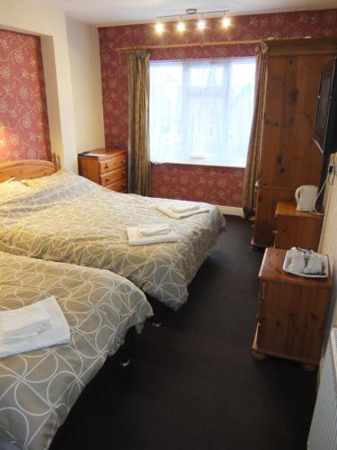 a hotel room with two beds and a window at The Monsell Hotel in Skegness