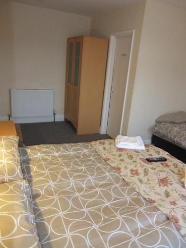 a hotel room with a large bed and a cabinet at The Monsell Hotel in Skegness