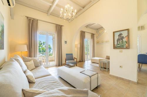 a living room with a white couch and a table at Villa Armonia in Pyrgi