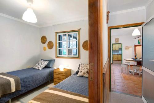 a bedroom with two beds and a dining room at Finca Candelario sc de La Palma in Santa Cruz de la Palma