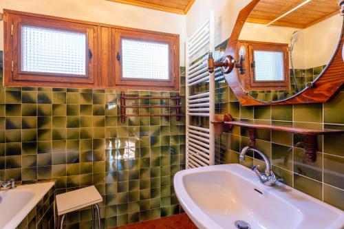a bathroom with a sink and a mirror at South-facing Chalet With Views in Saint-Chaffrey
