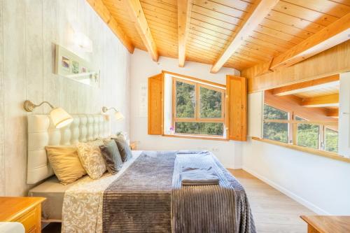 a bedroom with a bed and two windows at Panoramico in Oden