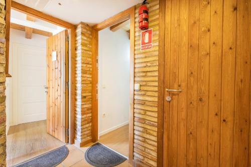 a hallway with wood paneled walls and a door at Panoramico in Oden
