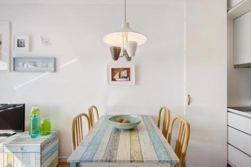a kitchen with a wooden table and chairs at Apartamento T1 - Salina Ria in Aveiro