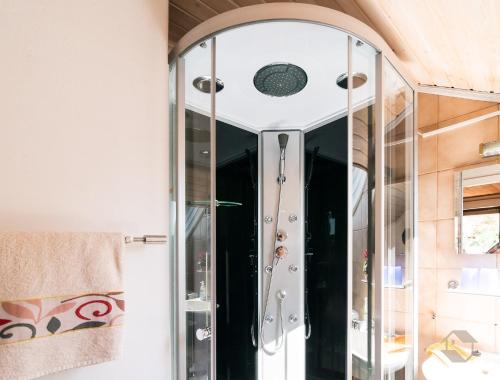 a shower with a glass door in a bathroom at Haus Umbeer in Schömberg