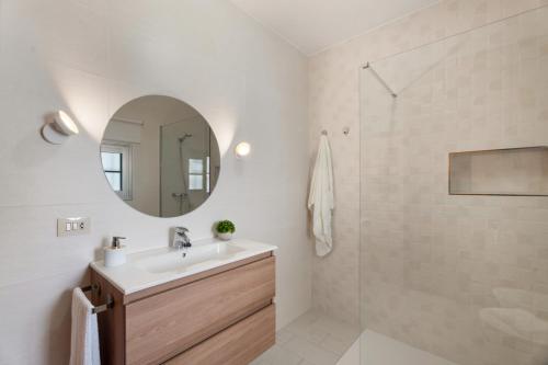 a bathroom with a sink and a mirror at Casa ino in Punta del Hidalgo
